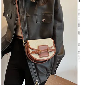 Retro canvas and brown leather saddle bag with metal buckle shown on a model side view