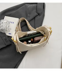 Interior view showing large capacity and compartments of the off-white bucket bag