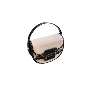 Minimalist saddle bag in beige canvas and black leather with a retro top handle