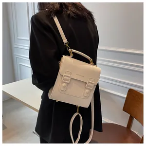 Detail view of cream vintage Cambridge backpack with matte leather texture and metal buckles