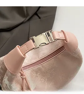 Detailed shot of pink jacquard fabric texture and golden buckle on a beaded handbag