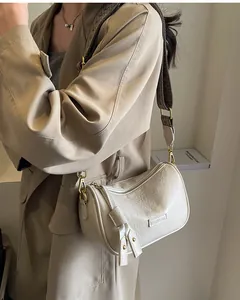 Detailed view of beige pleated bag with vintage logo strap and golden metal buckle