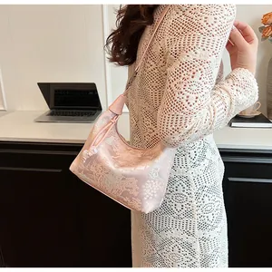 Detail of light pink satin hobo bag with traditional Chinese floral embroidery and beads