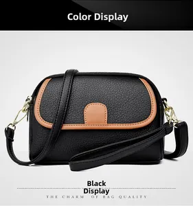 Detailed view of black genuine leather shoulder bag with lychee texture and gold metal hardware
