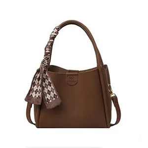 Classic dark brown tote bag in pebbled leather texture with a silk scarf handle accessory