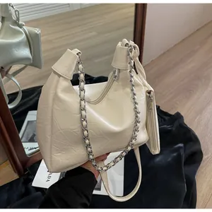 Detail of off-white pleated leather shoulder bag with silver chain and mini pouch