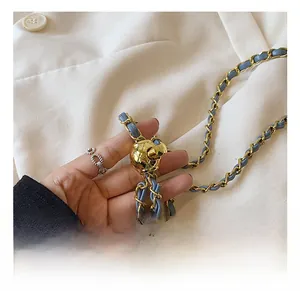Detail of light blue leather chain strap with golden sphere adjustment buckle for mini bag