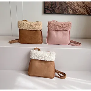 Three colors of faux suede and shearling crossbody bags displayed on a white step
