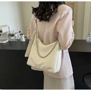 Detail of cream pleated hobo bag with silver chain and matching mini pouch attachment