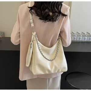Detail of off-white pleated leather tote bag with silver chain and matching mini pouch