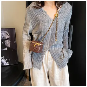 Deep brown quilted mini crossbody bag with gold chain and ball adjuster shown on model