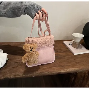Pink plush crossbody bag with furry texture, long strap and cute brown bear charm