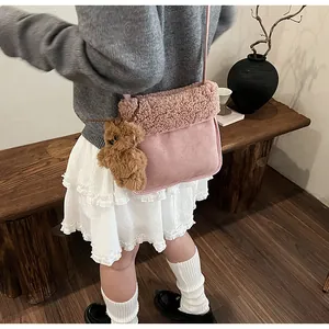Pink suede kids crossbody bag featuring plush fleece trim and a cute brown teddy bear charm