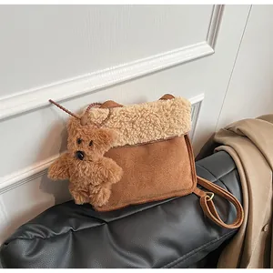 Detail of vintage brown suede tote bag with plush shearling trim and cute bear charm