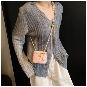 Pink quilted mini square crossbody bag with gold camellia metal detail and chain strap