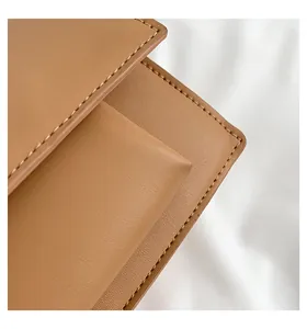 Detailansicht der braunen Ledertasche mit feinen Nähten und dem inneren Fach