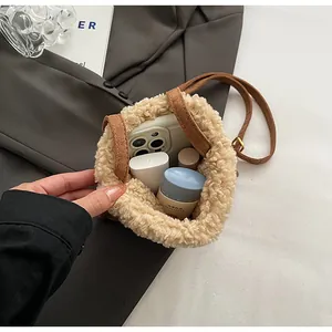 Internal view of beige faux shearling mini bag holding smartphone and cosmetics