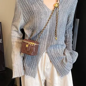 Brown quilted leather mini crossbody box bag with gold chain and camellia charm