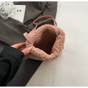 Close-up of pink plush mini bucket bag with soft fleece lining and slim shoulder strap