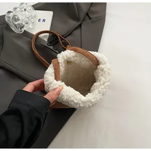 Close-up of brown faux suede bucket bag with white plush fleece lining for winter fashion