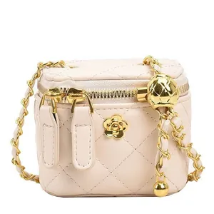 Quilted mini vanity bag in cream with adjustable gold ball chain and floral detail