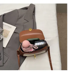 Internal capacity of the retro crossbody bag showing space for phone and wallet