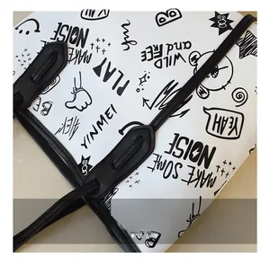 Close-up of doodle print patterns and precise stitching on large white tote bag