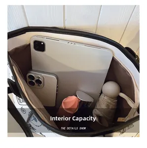 Detail view of the spacious interior capacity showing art print tote with brown lining