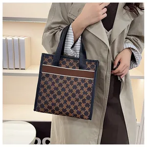 Detailed shot of vintage monogram tote bag with brown stripes and black woven handles