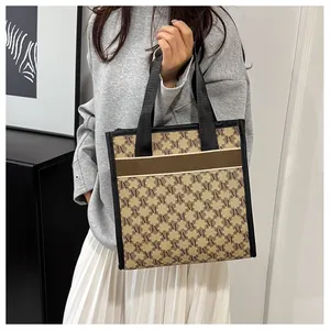 Detailed macro shot of the vintage monogram pattern and textured fabric on the tote bag