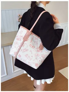 Detailed side view of a large tote bag with cute pink graffiti and cartoon prints
