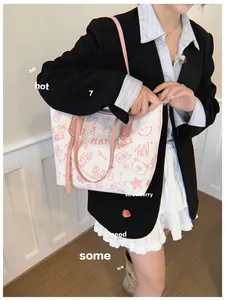 Detail of white tote bag with cute pink bear graffiti prints and pink shoulder straps