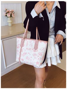 Detail view of large tote bag with cute pink cartoon graffiti and contrast pink straps