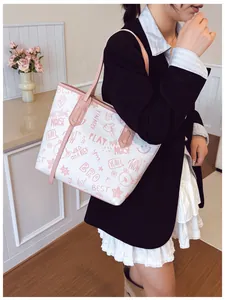 Close-up of large tote bag featuring cute pink graffiti prints and heart star motifs