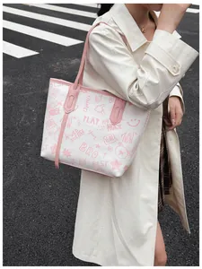 Detail of a white tote bag with pink graffiti lettering and cute cartoon bear patterns
