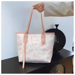 Close-up of large white tote bag with pink straps and cute cartoon bear graffiti prints