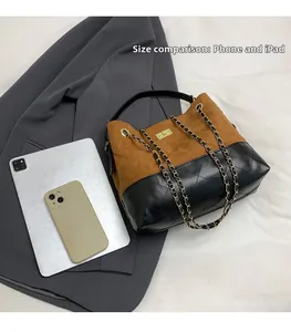 Suede tote bag size comparison with an iPad and smartphone on a grey blazer