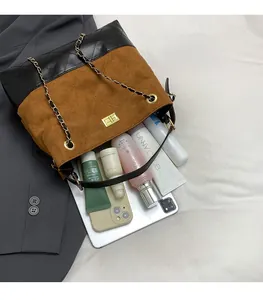 Close-up of the quilted faux suede tote showing spacious interior for tablet and cosmetics