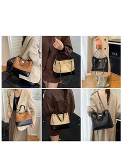 Detail view of large faux suede tote bags featuring metal chain straps and diamond quilting