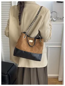 Detail of retro contrast shoulder bag with quilted stitching and gold metal twist lock