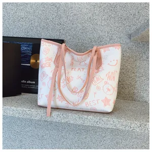 Detail of white tote bag with pink trim featuring cartoon bear and graffiti patterns
