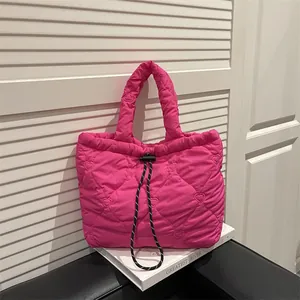 Magenta heart-quilted puffy dumpling bag with black and white drawstring straps