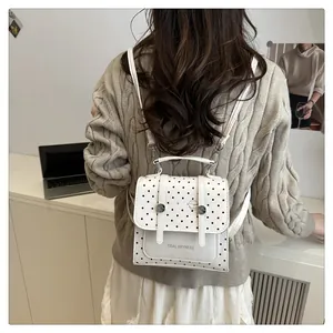 Rückansicht eines weißen gepunkteten Rucksacks an einem Modell für die tatsächliche Passform