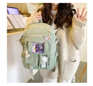 Dettaglio dello zaino in nylon verde chiaro con patch arcobaleno e ciondolo a forma di pecora