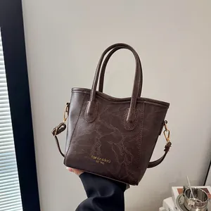 Retro dark brown leather tote bag with gold lettering and adjustable shoulder strap