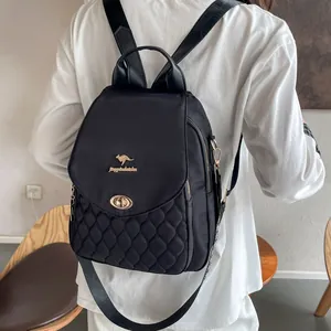 Close-up of lightweight black quilted backpack with golden buckle and kangaroo logo