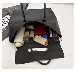 Top view of spacious black tote bag showing interior storage for tablet and umbrella