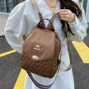 Close-up of brown quilted backpack with kangaroo logo and stylish pattern strap
