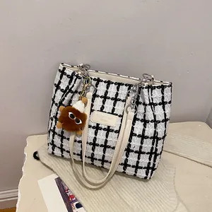 Large black and white plaid tweed tote bag with leather strap and plush charm