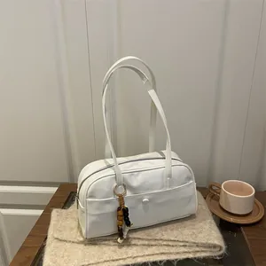 Chic white PU leather bowling handbag on a cozy knit scarf with a wooden bead charm